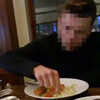 man eating salad with his hands